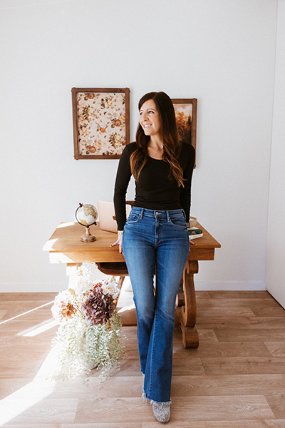 Tia Power Standing against a desk